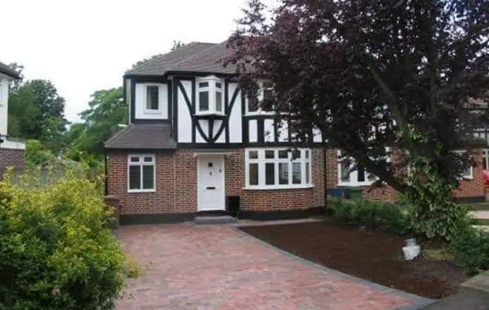 Traditional house with brick driveway after extension
